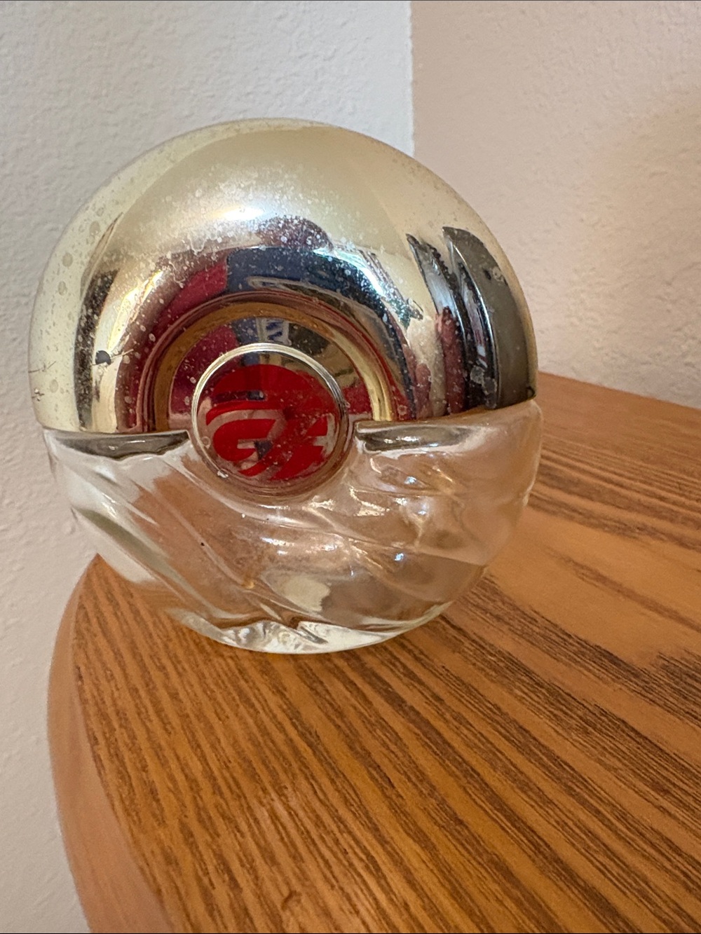 Avon Foxfire, empty, Round Silver-Tone Glass Decorative Bottle with Red Emblem